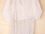 an image of a white shirt hanging on a wooden wall