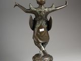an image of a bronze statue of a woman with a hat on her head