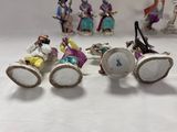 many figurines of people sitting on a white surface