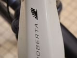 a close up of a bike with a black and white logo on it