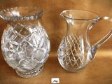two glass pitchers sitting next to each other on a table