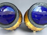 pair of blue glass and gold - plated cufflinks on a white background