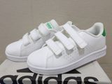 a pair of white tennis shoes on top of a box