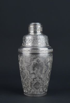 a silver plated cocktail shaker on a black background