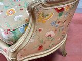 a chair with a floral pattern on it in a room