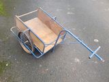 a cart with a wooden box on the back of it