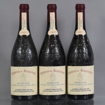 three bottles of wine are lined up on a table