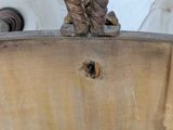 a close up of a rope on the handle of a wooden chair