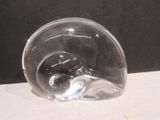 a clear glass object on a table with a black background