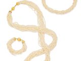 un ensemble composé d'un collier et d'un bracelet blancs ornés de perles dorées