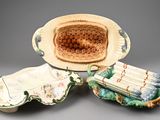 three pieces of pottery that are sitting on a table