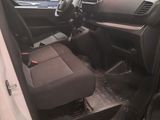 the interior of a car with the door open showing the driver ' s seat