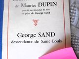 a pink post it note on the table next to a book