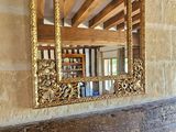 a fireplace with a mirror on top of it in a room