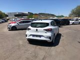 the rear end of a white car parked in a parking lot