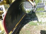 a snow plow that is sitting on the ground