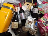 many bottles of wine and other items in a basket