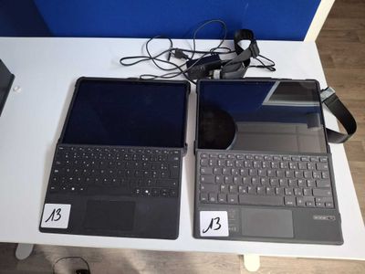 two laptops that are sitting on a table