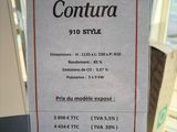 a picture of a sign on a table that says contura