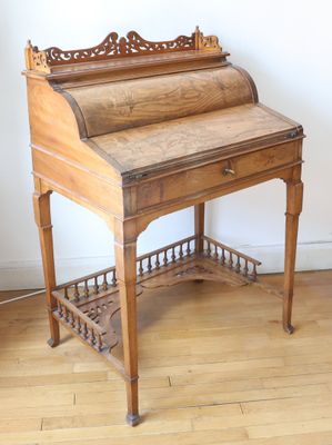 a wooden desk with a roll top on top of it