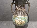 a bronze vase with a blue and gold design on it