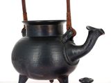 a black tea pot with a wooden handle and a lid