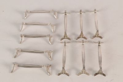 six pairs of silver plated spoons and forks on a white surface
