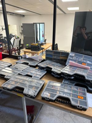many boxes of tools on a table in a room