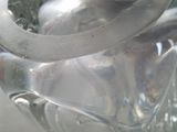 a clear glass vase with a silver lid on a table