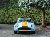 a blue and yellow car parked next to a tree