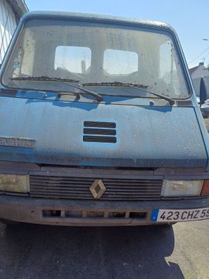a blue van that is parked on the side of the road