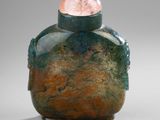 an image of a glass bottle with a pink stone in the top