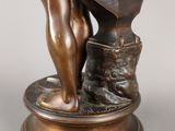 a bronze statue of a man holding a hammer and an anvil