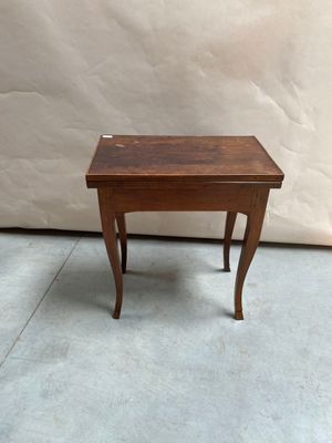 a small wooden table with a small drawer on it