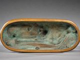 an image of a bronze sculpture of a boat on a body of water