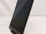 a tablet that is sitting on a stand on a white surface