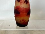 a glass vase with a picture of a woman on it