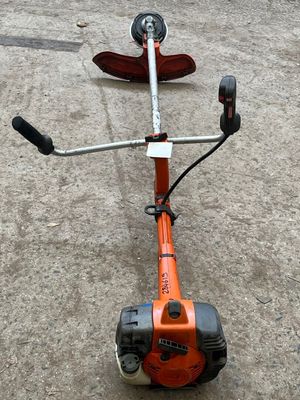 an image of a small lawn mower on the ground