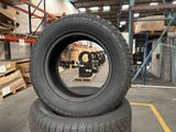 a tire sitting on top of a pile of pallets in a warehouse