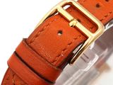 a close up of a wrist watch with a gold buckle