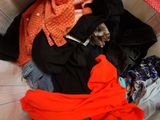 a pile of clothes in a basket on the floor
