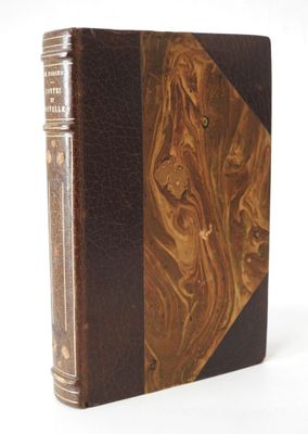 an old book with a brown leather cover and a wooden cover