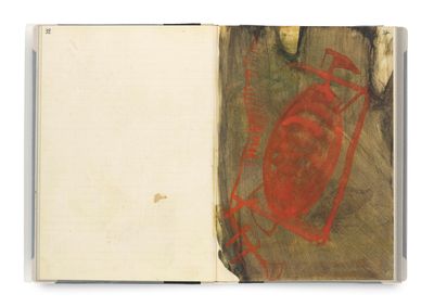 an open book with a drawing of a red circle on it