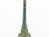 a close up of a green vase on a white surface