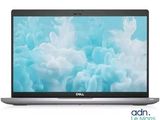 the dell laptop is open on a white surface with a blue background