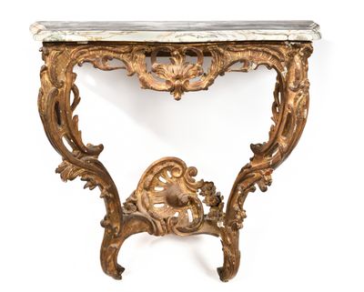 an ornately carved console table with marble top
