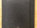 a black piece of paper with a ring on it on a table