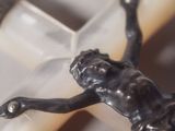 a statue of a man laying on a cross