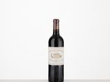 the bottle of wine is sitting on the table with a white background