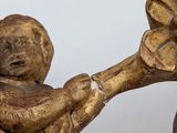 a statue of a baby holding a flower in its hand